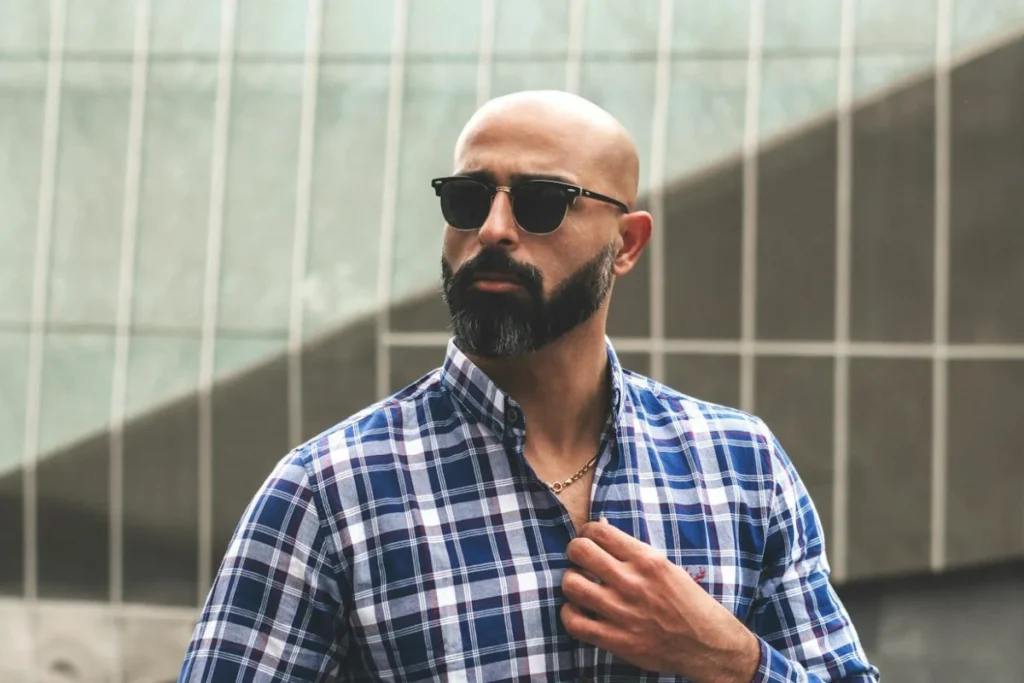 how to polish a bald head without irritation. A bald-headed man with sunglasses and a necklace