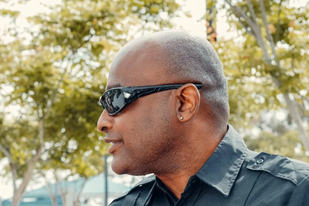 A bald-headed man with sunglasses