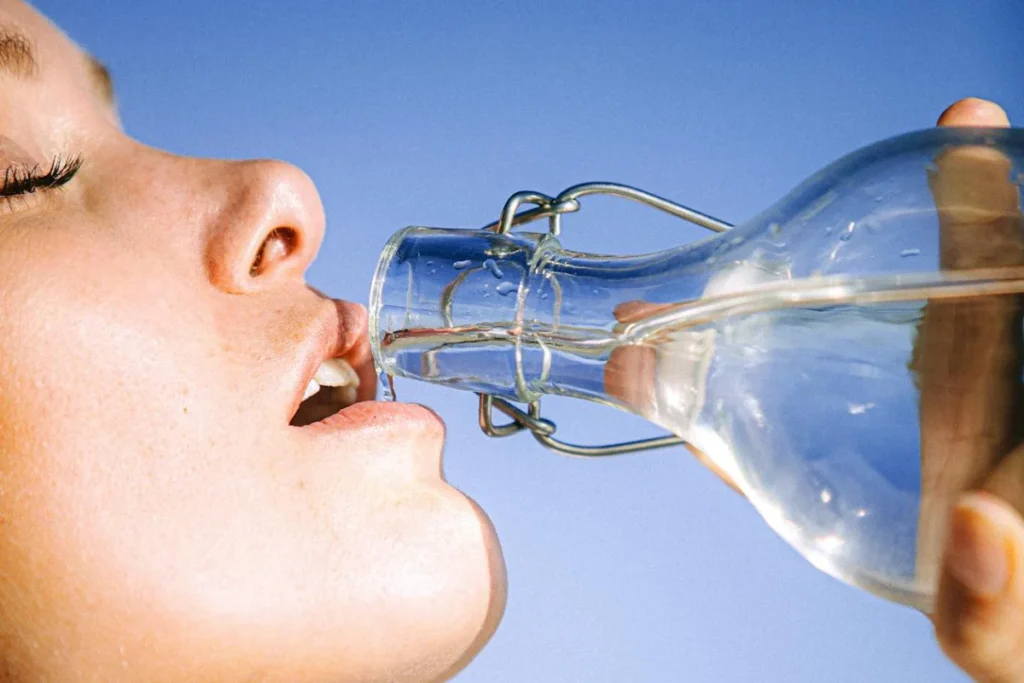 A woman is drinking water