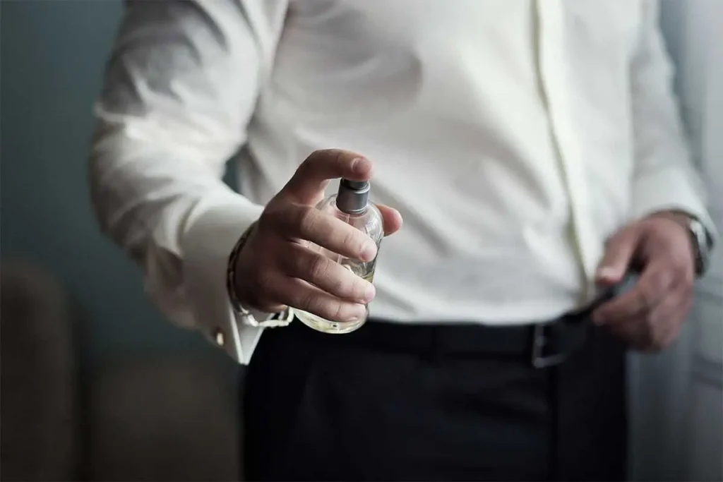 a man with a fragrance in his hand