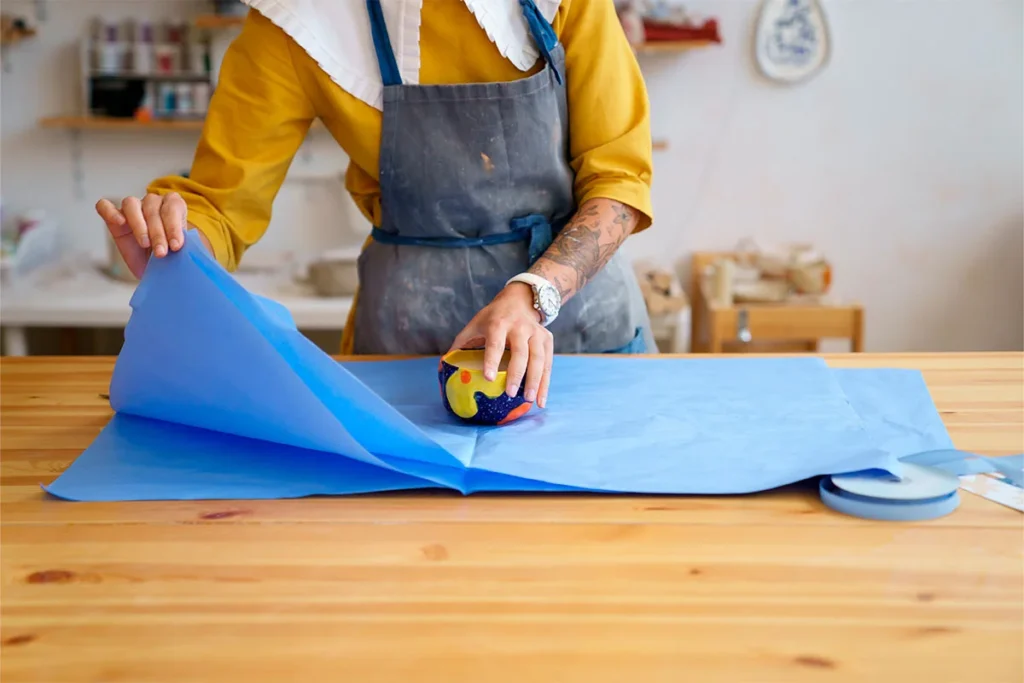 person measuring and preparing fabric