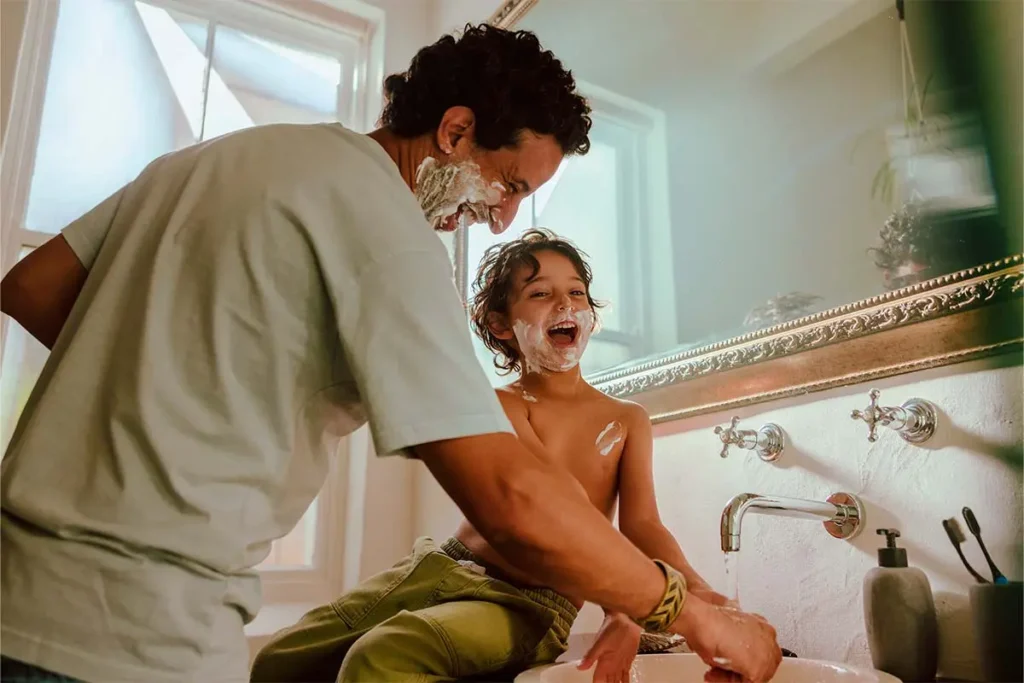 a man with his son playing with shaving cream