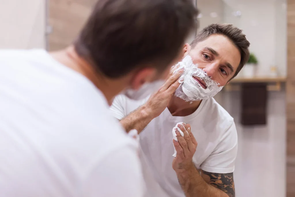 man shaving in front of the mirror