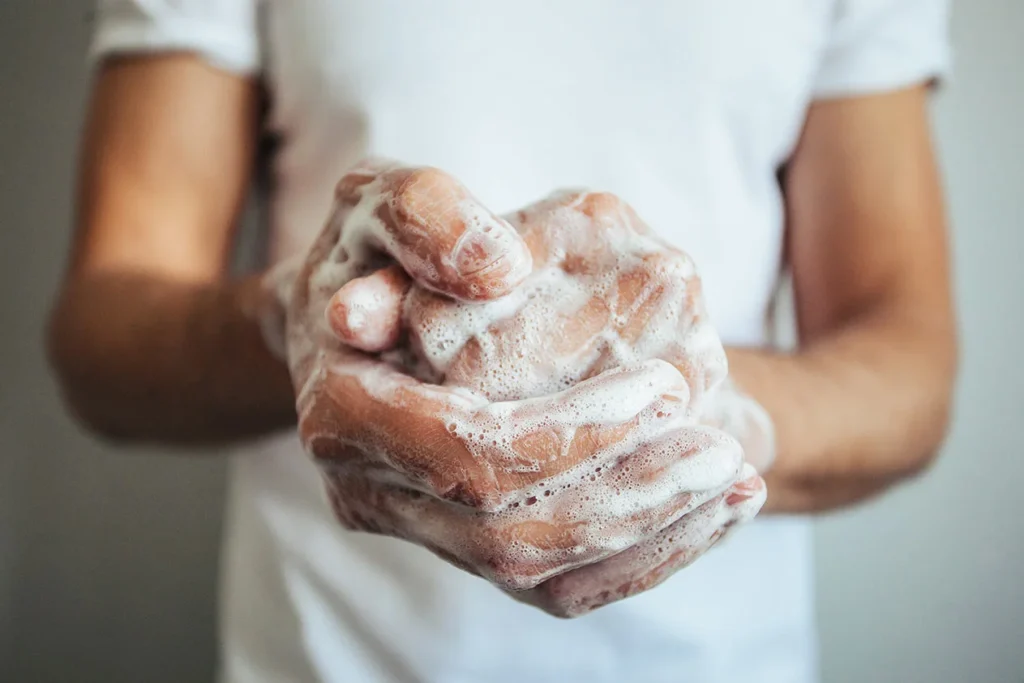 A person's hands while washing them