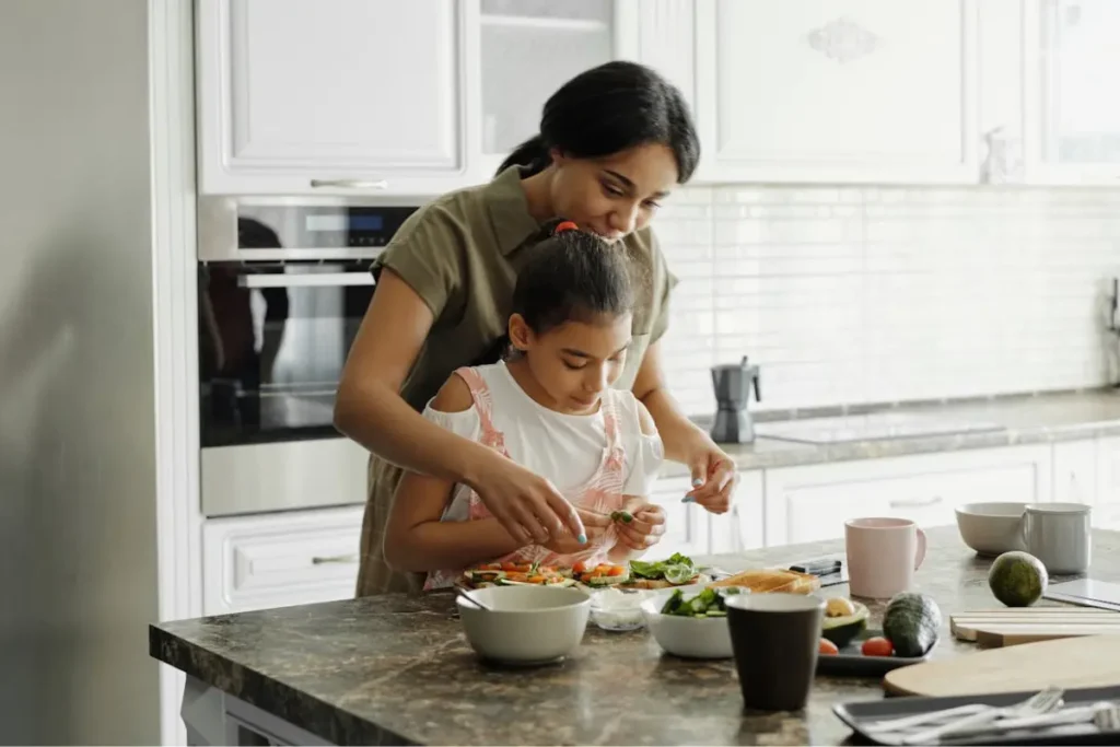 a woman and her daughter cooking a healthy meal